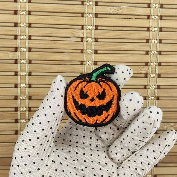 small Evil Pumpkin Embroidered Patch on holding hand