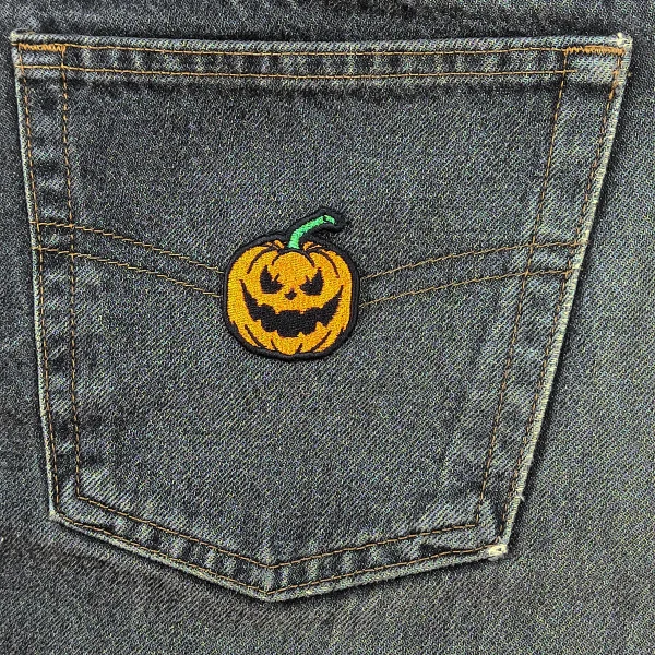 small Evil Pumpkin Embroidered Patch on black jeans