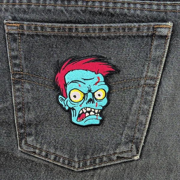 Bald Zombie Head Embroidered Patch on black jeans