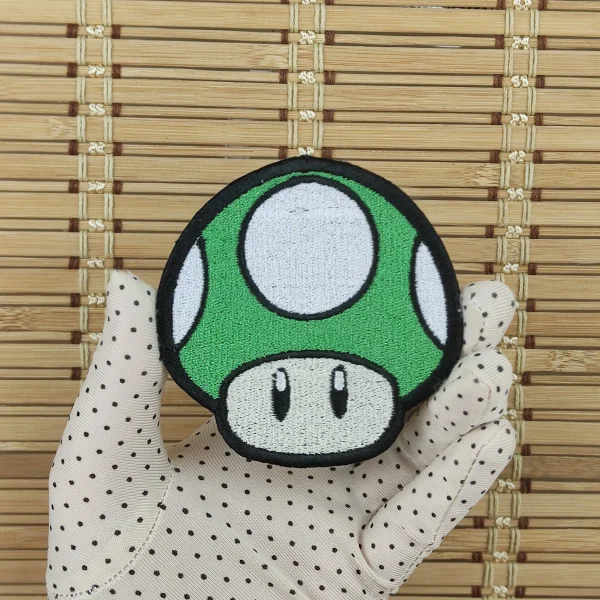 medium green Kawaii Mushroom Embroidered Patch on holding hand