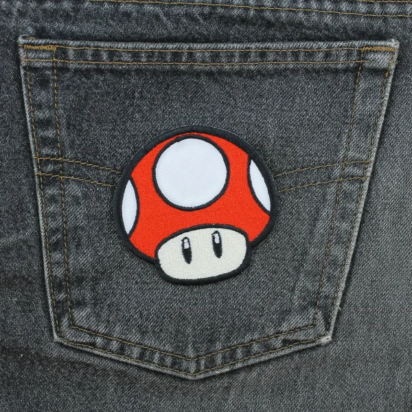 medium red Kawaii Mushroom Embroidered Patch on black jeans