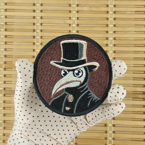 Steampunk style plague doctor embroidered patch in hand